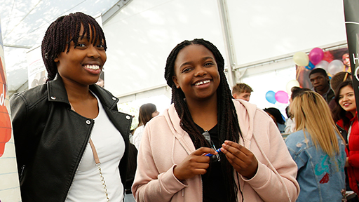 two students smile at a fair