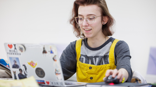 Female with glasses drawing on an ipad