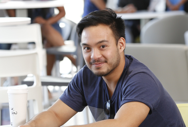 Asian male smiling into the camera