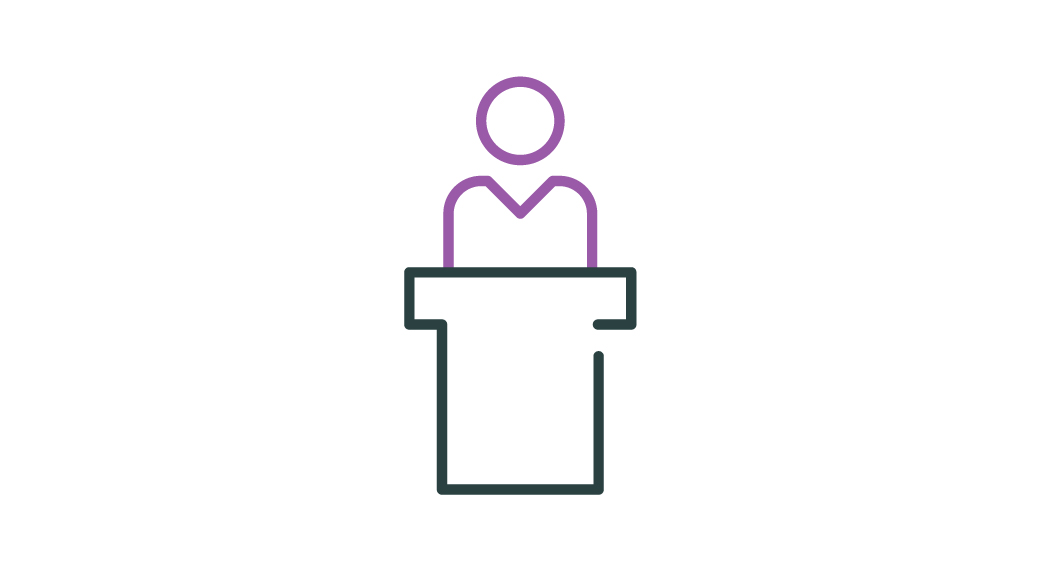 Image of a stick person standing behind a lecturn