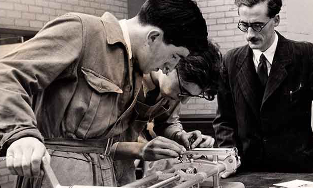 Students and academic looking at engineering equipment